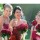 Bridesmaids in burgundy dresses with matching frangipani posies