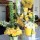 Contemporary buffet table arrangement of yellow and white flowers