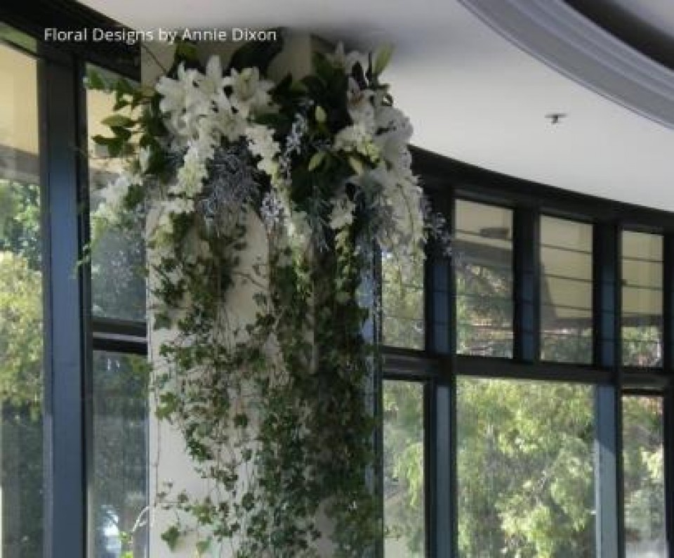 Arrangement of Casablanca Lilies and Singapore Orchids cascading from ceiling