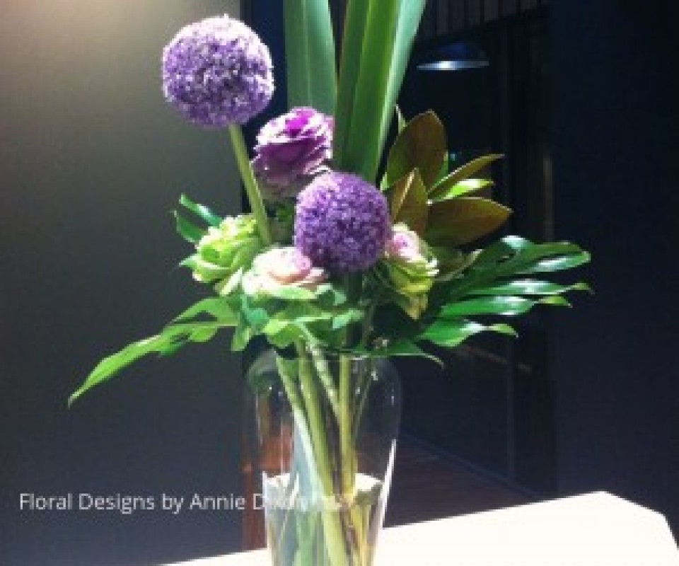 Contemporary arrangement of Alliums and Kale on bar