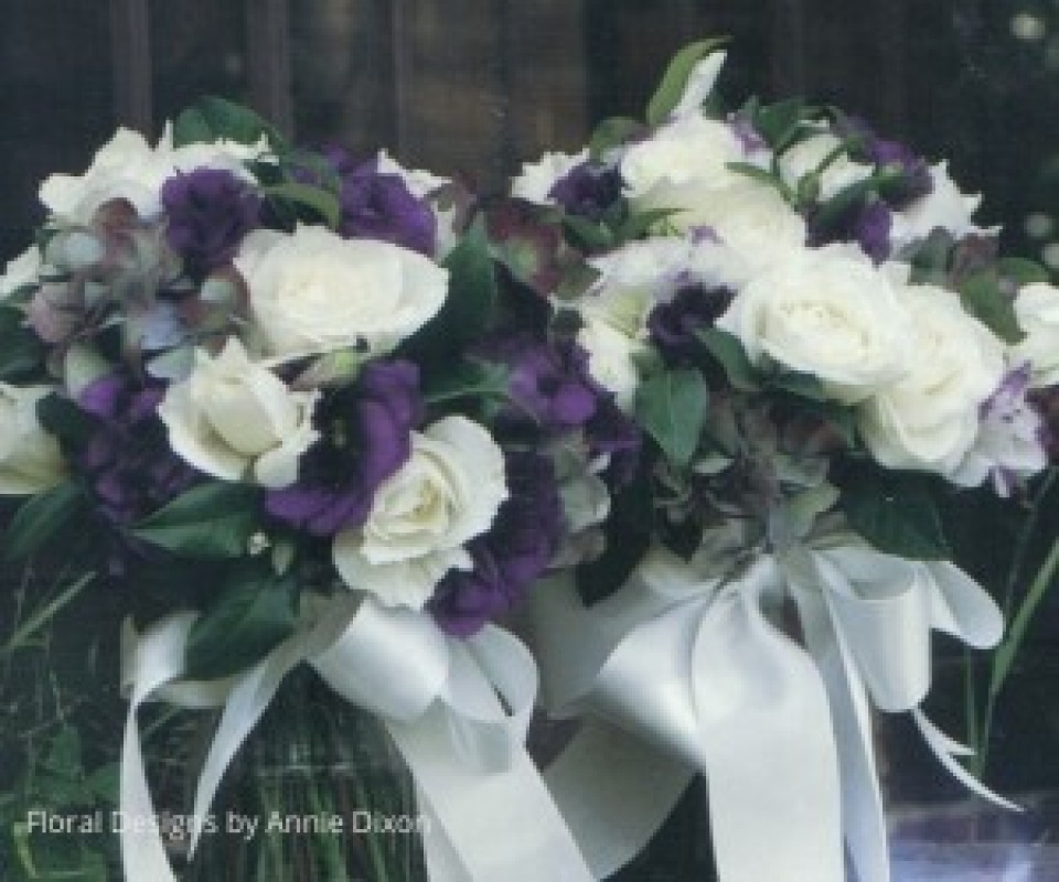 Bridemaids' posies of purple lisianthus, ivory roses and autumn hydrangea