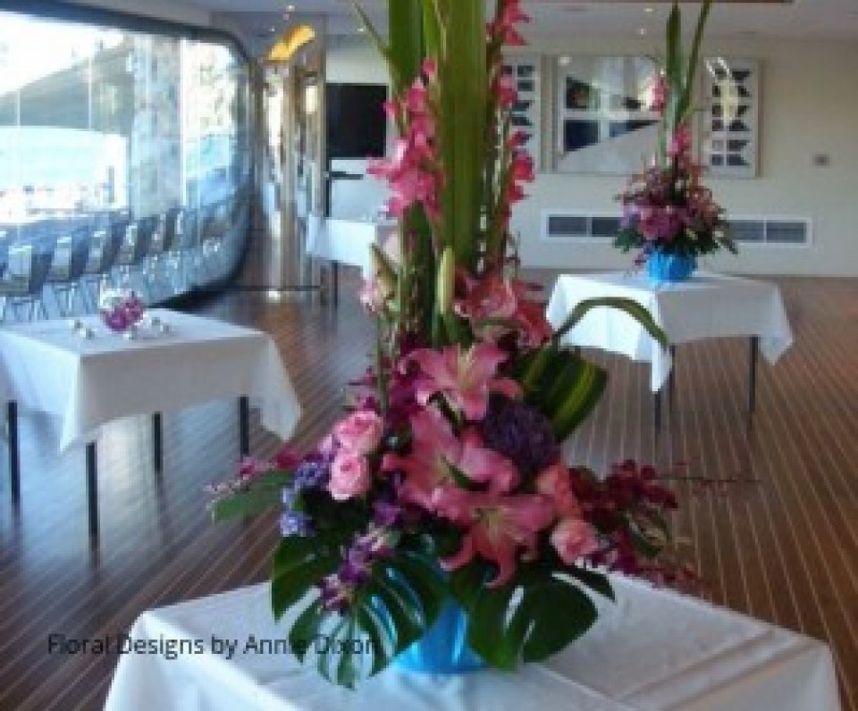 Two pink centrepiece arrangements of Gladioli, Oriental Lilies, Hydrangea, Roses and Orchids