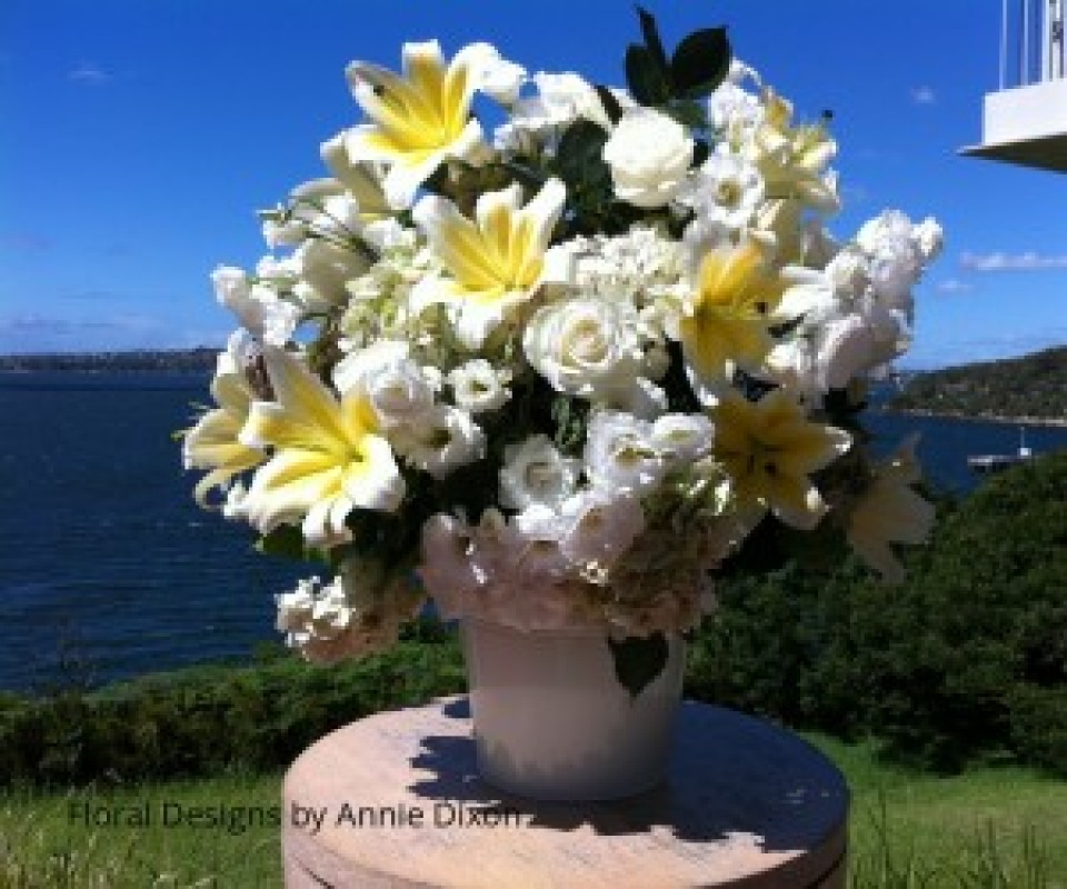 Large arrangement of lemon and white flowers for outdoor wedding ceremony overlooking Chowder Bay