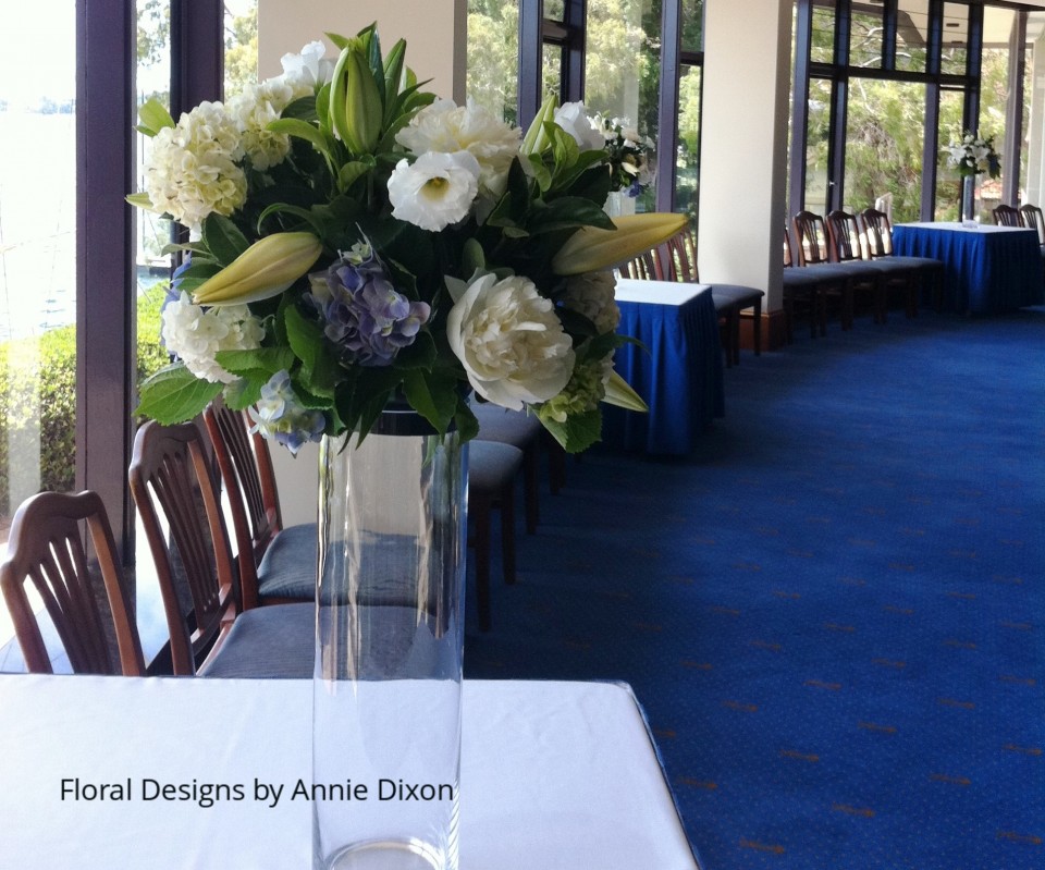Blue and white glass cylinder arrangements in bay windows