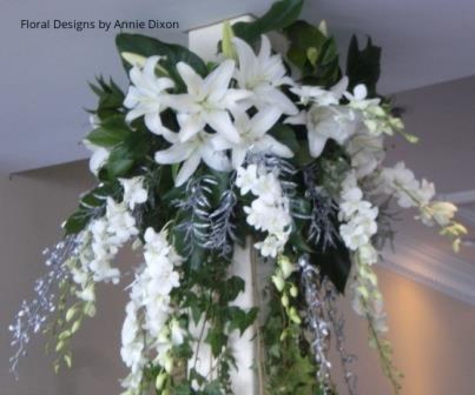 Close up of large silver and white arrangement cascading from ceiling