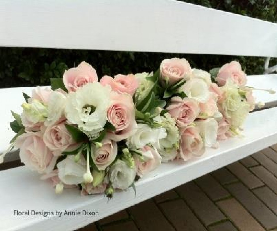 Posies of Sweet Avalanche roses, lisianthus and bouvardia on garden bench